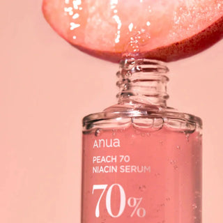 Anua Peach 70 Niacin Serum 30mL bottle, clear glass container with a white pump dispenser, showing the skincare product.