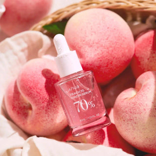 ANUA Peach 70 Niacin Serum 30mL bottle featuring a clear glass container with a peach-colored liquid inside.