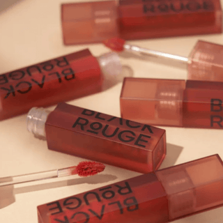 Black Rouge Air Fit Velvet Tint 9 lip tint in a sleek black tube, showing its vibrant, velvety texture and applicator.