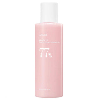 Anua Peach 77 Niacin Conditioning Milk emulsion bottle with peach-colored label and white cap, close-up view.