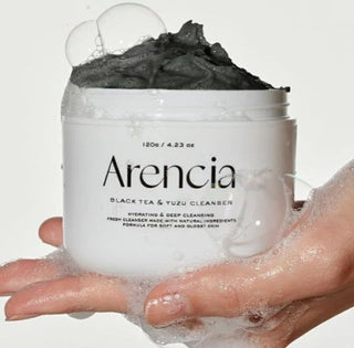 ARENCIA Black Tea Rice Mochi Cleanser 120g with a white tube and black cap, featuring images of black tea and rice mochi on the packaging.