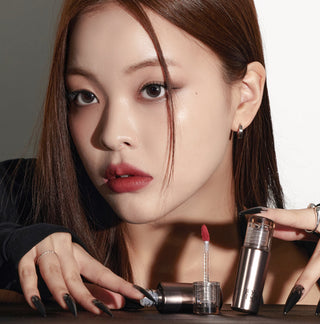 Black Rouge Icy to Fog Velvet lip tint in pink, showcasing the sleek black tube and the vibrant pink shade of the product.
