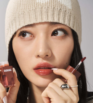 Black Rouge Glow Bokki Lip Tint in Pepper Red, showcasing the vibrant red shade and sleek packaging of the lip tint product.