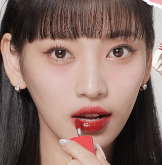 Black Rouge Glow Bokki Lip Tint in Pepper Red, showing the vibrant color and sleek packaging of the lip tint product.