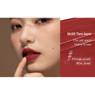 Black Rouge Double Layer Over Velvet lipstick featuring a sleek black tube and salmon-colored lipstick inside.