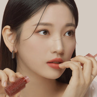 Black Rouge Double Layer Over Velvet lipstick with salmon and black layers, showcasing its sleek, dual-tone design in a close-up image.
