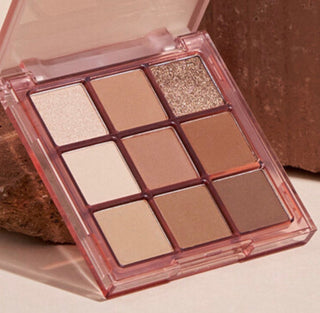Black Rouge Colordation Mood Palette makeup with warm-toned eyeshadows in a sleek black compact.