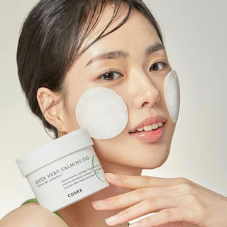 COSRX One Step Green Hero Calming Pad with 70 sheets, soothing skincare product in a clear plastic container.