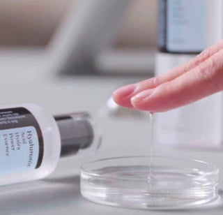COSRX Hyaluronic Acid Hydra Power Essence in a 100ml bottle, featuring clear liquid and pump dispenser for hydrating skincare.