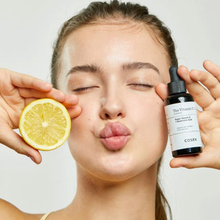 Cosrx The Vitamin C 13 Serum bottle with dropper, clear liquid serum for brightening and skin radiance, in a white and orange packaging
