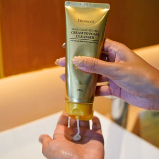 Deoproce Snail Galac Revital Cleansing Foam in 100g tube, showing the product packaging and foam texture.