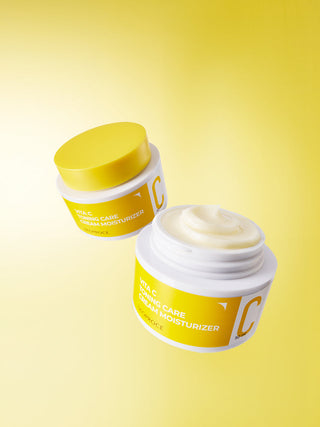 Deoproce Vita C Toning Care Cream Moisturizer in a white jar with a pink and white label, surrounded by fresh citrus slices.