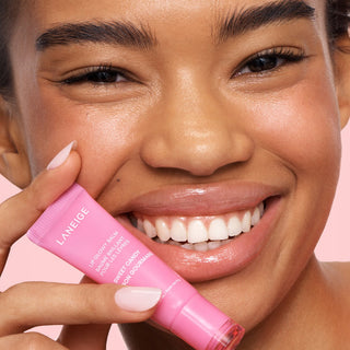 Laneige Lip Glowy Balm in a clear container showing the moisturizing balm, available in five different types, brand logo visible.