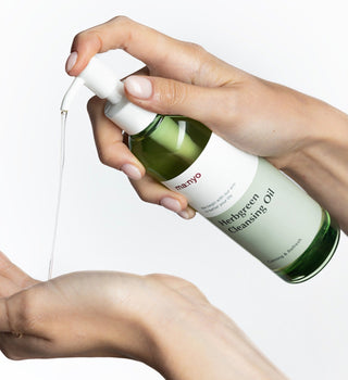 ma:nyo Herb Green Cleansing Oil bottle with green label and pump dispenser, 200ml size, for gentle facial cleansing