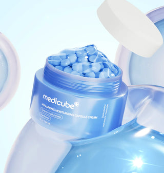 Medicube Hyaluronic Moisturizing Capsule Cream 50g jar showing the cream's smooth texture in a sleek container.