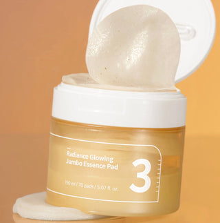 Numbuzin No.3 Radiance Glowing Jumbo Essence Pad showing a close-up of the large, soft cotton pad with product packaging in the background.