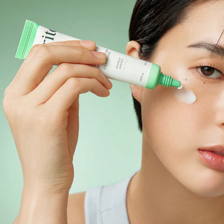 Purito Seoul Wonder Releaf Centella Eye Cream in a 30mL jar, unscented, with a smooth, hydrating texture and soothing eye care formula.