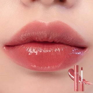 rom&nd The Juicy Lasting Tint lip tint in pink pumpkin shade, showcasing the vibrant, glossy finish on lips.