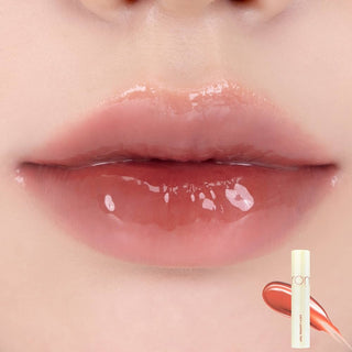 Rom&nd the Juicy Lasting Tint in Papaya Jam, a vibrant orange lip tint with a glossy finish, shown in the tube.