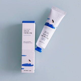 Cream container labeled ROUND LAB Birch Juice Hand Cream 30ml, showcasing the product's packaging and design.