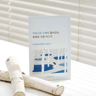 ROUND LAB Birch Juice Moisturizing Sheet Mask showing the round, white sheet mask ready for facial application.