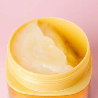 Shiseido Tsubaki Premium EX Repair Hair Mask 180g in a white jar with pink accents, designed for nourishing hair care.