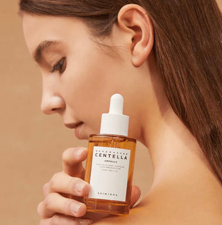 Skin1004 Madagascar Centella Ampoule serum in a 30ml bottle, with a clear glass container and white pump dispenser.