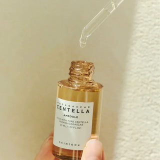 Skin1004 Madagascar Centella Ampoule serum in a 30ml bottle, showcasing the clear, lightweight skincare product.