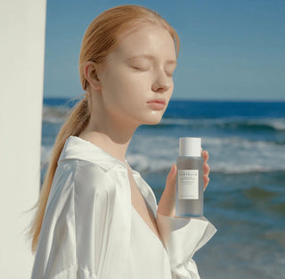 Skin1004 Madagascar Centella Hyalu-Cica Brightening Toner in a 30ml bottle, showing the clear liquid and branding.