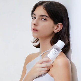 Skin1004 Madagascar Centella Brightening Toner and Emulsion, displaying the soothing, clear liquid in a skincare bottle.