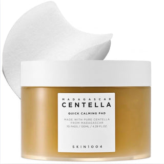 Skin1004 Madagascar Centella calming toner pads laid out on a clean surface, showing their round shape and packaging.