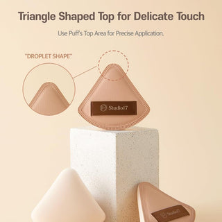 Studio 17 Pang Pang Triangle Puff for makeup application, soft foam makeup tool with a triangular shape.