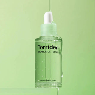 Torriden Balanceful Cica Serum 50mL in a clear bottle with a pump, featuring a minimalist design and light green label.