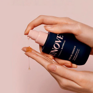 Unove Silk Oil Essence 70ml in a clear bottle, showcasing the hair essence with a smooth, glossy appearance and sleek packaging.
